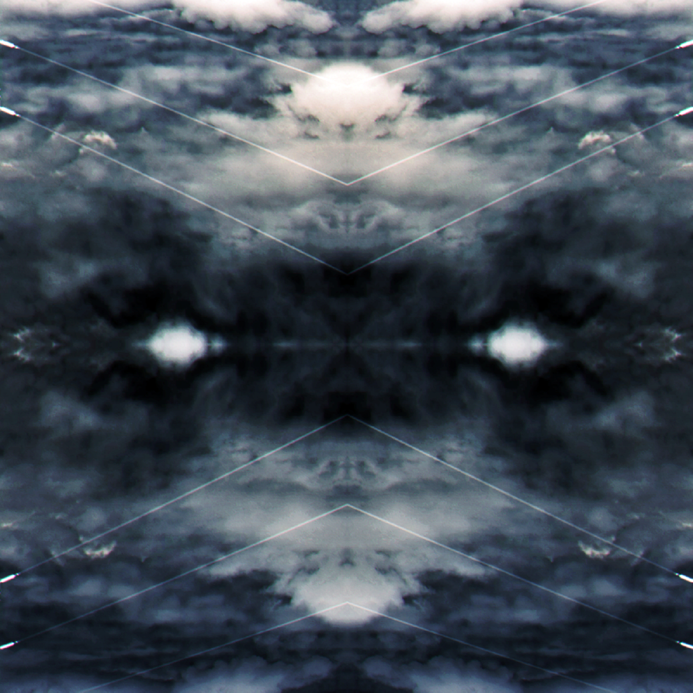 Dark storm-clouds mirrored both vertically and horizontally form what resembles a column of cloud and two eyes.